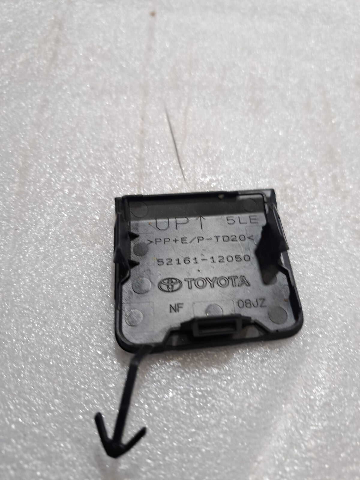 2019-22 Toyota Corolla. Used OEM rear bumper tow hook cover (52161-12050) -'